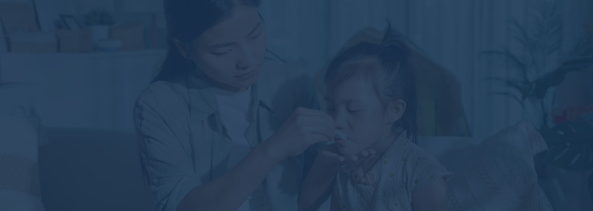 mom with child administering medicine