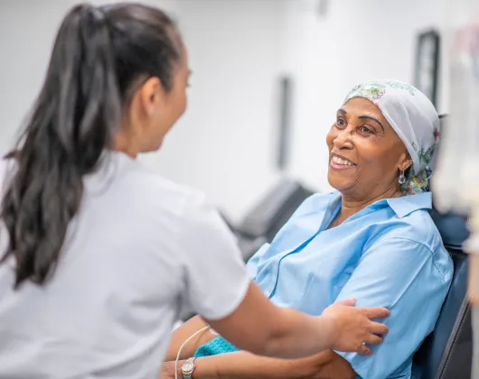 A nurse with a woman receiving a treatment