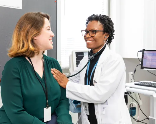 Doctor with healthy volunteer in clinical trial facility